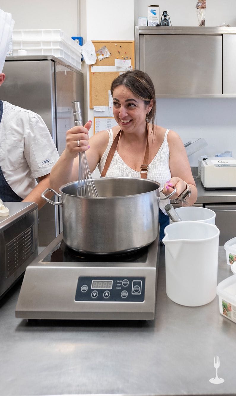 Gelato base induction hob Smiling guest whisking the pot on the induction hob in the pastry lab.