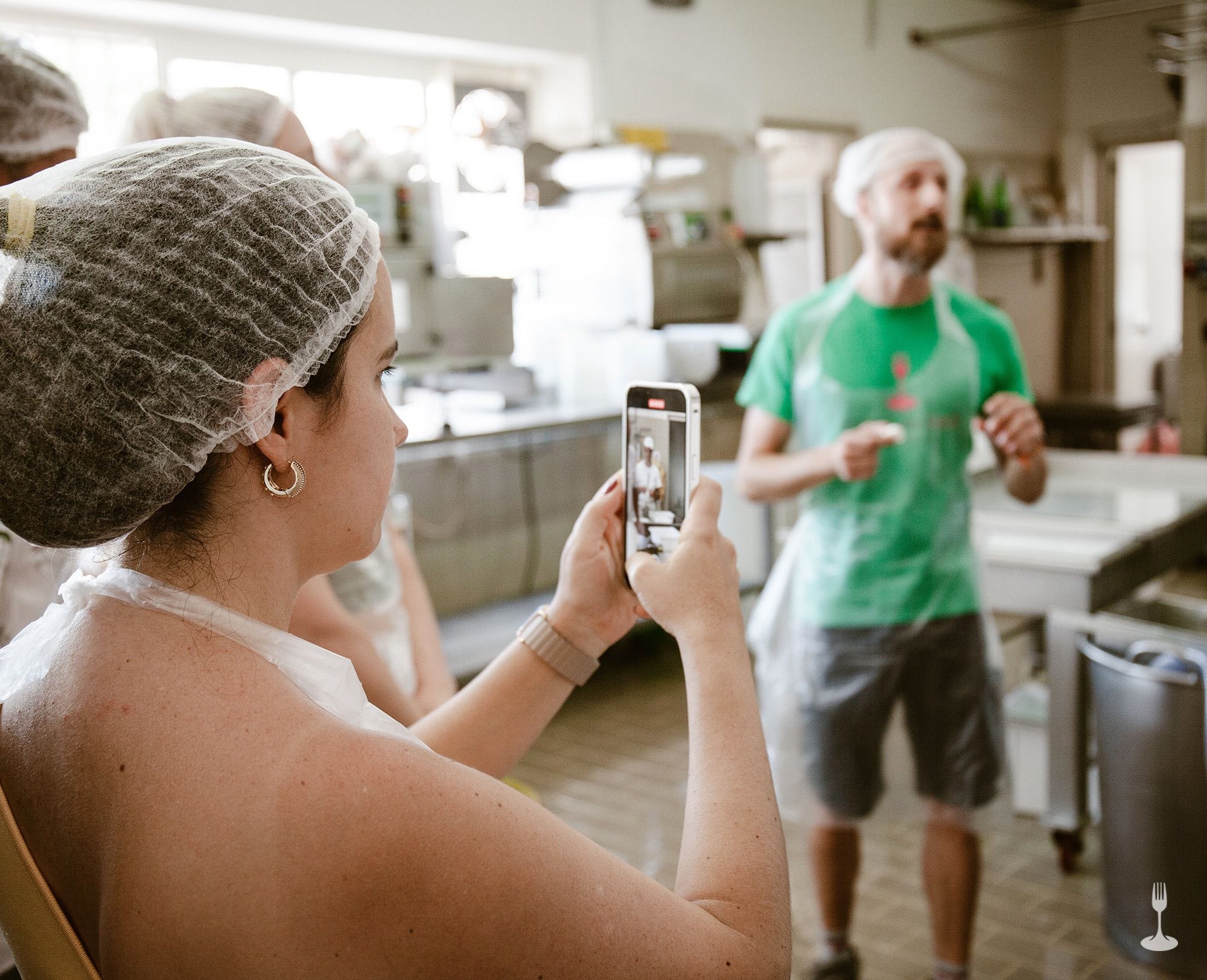 Guest taking picture Guest using her smartphone to record the mozzarella-making process.